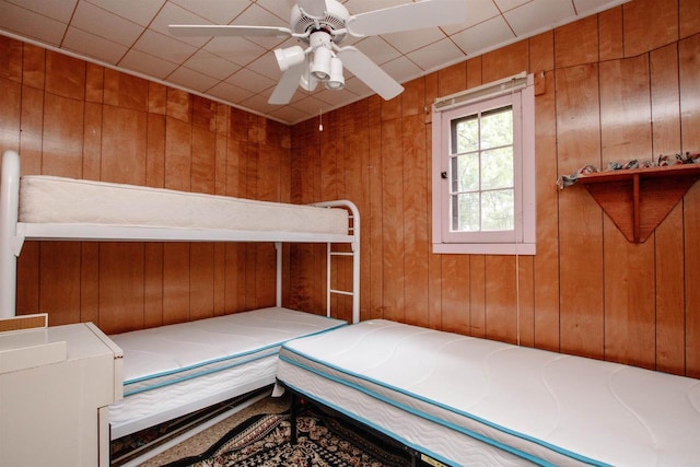 W5522 S Round Lake Rd, Wild Rose, WI 54984 - unfurnished bedroom featuring wooden walls and a ceiling fan