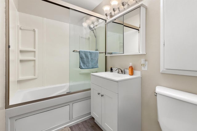 1413 E Marquette St, Appleton, WI 54911 - bathroom with vanity, bath / shower combo with glass door, toilet, and wood finished floors