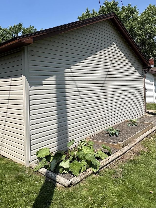 1413 E Marquette St, Appleton, WI 54911 - view of property exterior with a vegetable garden