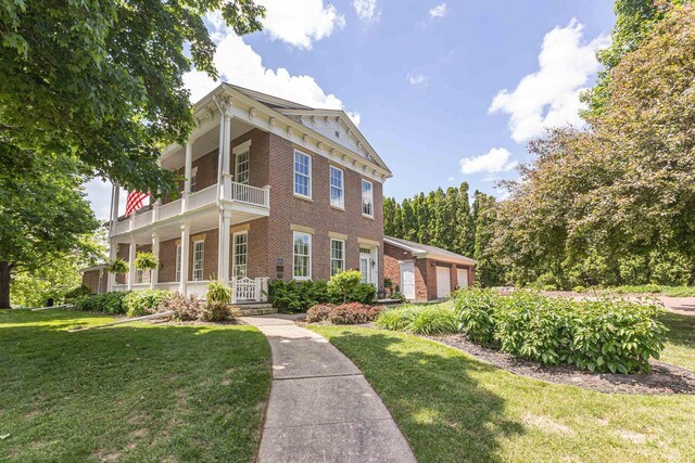150 Rountree Ave, Platteville, WI 53818 - italianate house with brick siding, a balcony, and a front lawn