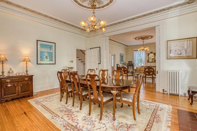 150 Rountree Ave, Platteville, WI 53818 - dining space with a chandelier, radiator, ornamental molding, stairs, and light wood-style flooring