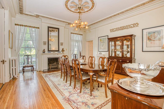 150 Rountree Ave, Platteville, WI 53818 - dining area featuring a chandelier, ornamental molding, and light wood-style floors
