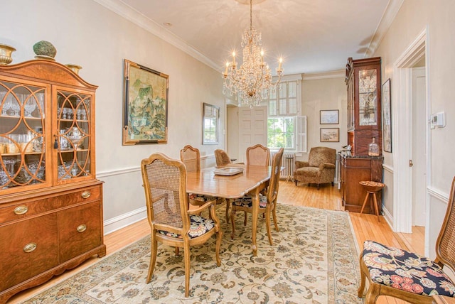 150 Rountree Ave, Platteville, WI 53818 - dining space with a chandelier, light wood-type flooring, ornamental molding, and a wainscoted wall