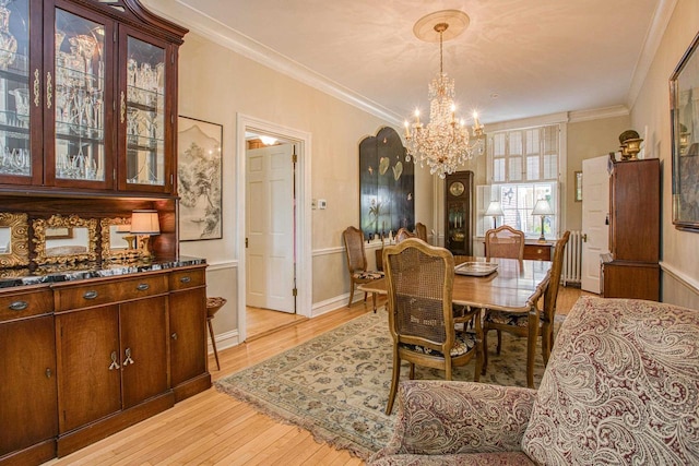 150 Rountree Ave, Platteville, WI 53818 - dining room with a chandelier, light wood finished floors, crown molding, and baseboards