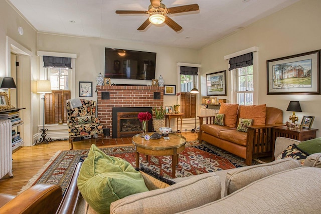 150 Rountree Ave, Platteville, WI 53818 - living room featuring healthy amount of natural light, a ceiling fan, wood finished floors, and a brick fireplace