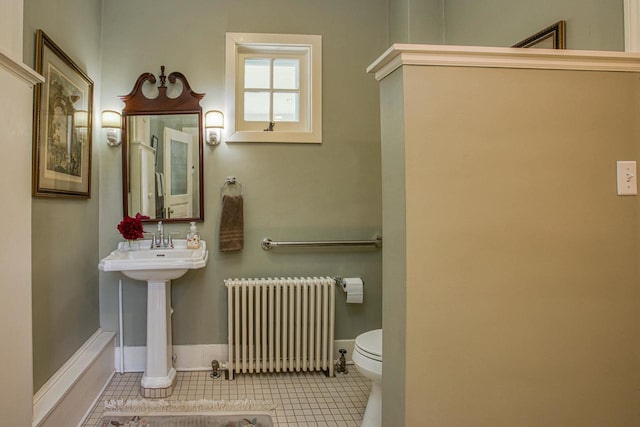150 Rountree Ave, Platteville, WI 53818 - half bath featuring radiator, toilet, baseboards, and tile patterned floors