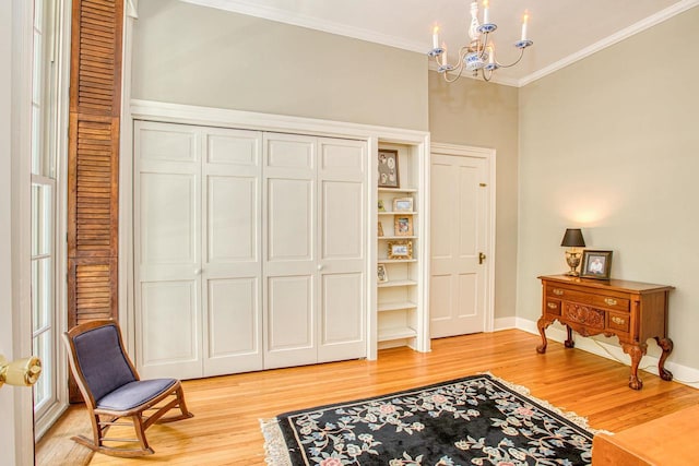 150 Rountree Ave, Platteville, WI 53818 - living area with a chandelier, light wood-type flooring, crown molding, and baseboards