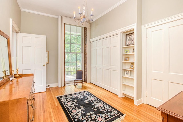 150 Rountree Ave, Platteville, WI 53818 - entryway with light wood-style floors, a chandelier, crown molding, and baseboards