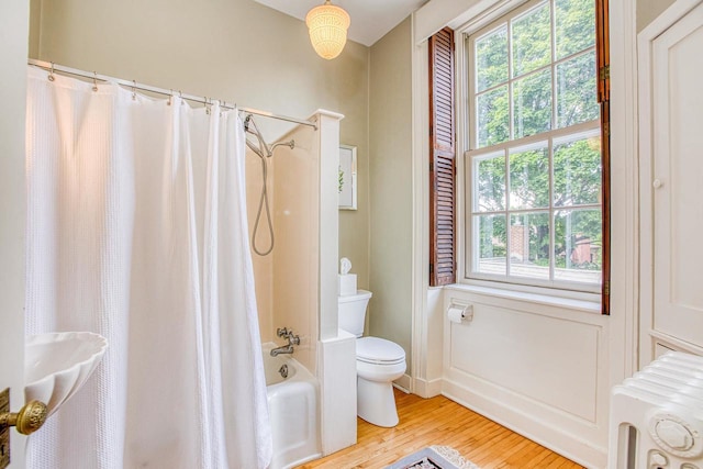 150 Rountree Ave, Platteville, WI 53818 - bathroom featuring toilet, radiator heating unit, wood finished floors, and shower / tub combo