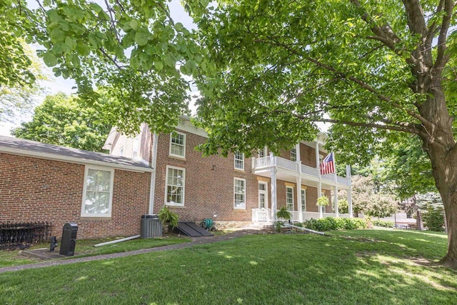 150 Rountree Ave, Platteville, WI 53818 - view of front of home featuring brick siding, a front lawn, cooling unit, and a balcony