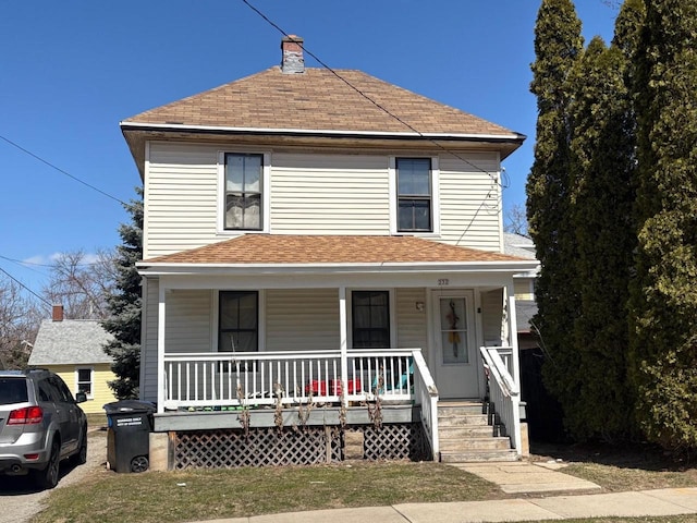 232 W Lincoln Ave, Oshkosh, WI 54901 - american foursquare style home with covered porch, roof with shingles, and a chimney