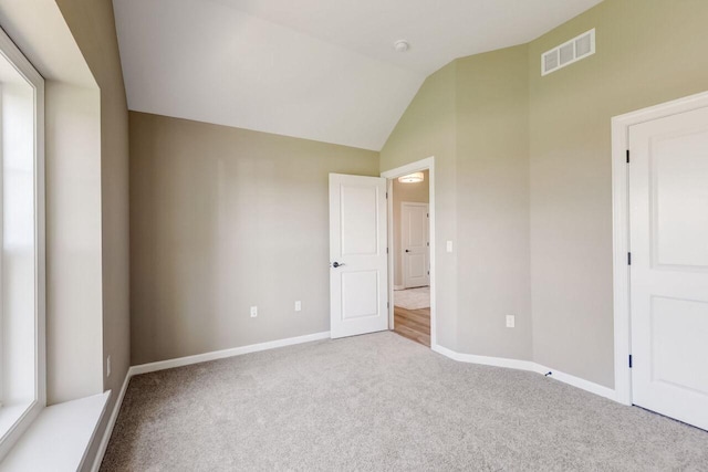 1320 Prairie Creek Cir Unit 2, Oconomowoc, WI 53066 - unfurnished bedroom with carpet floors and vaulted ceiling