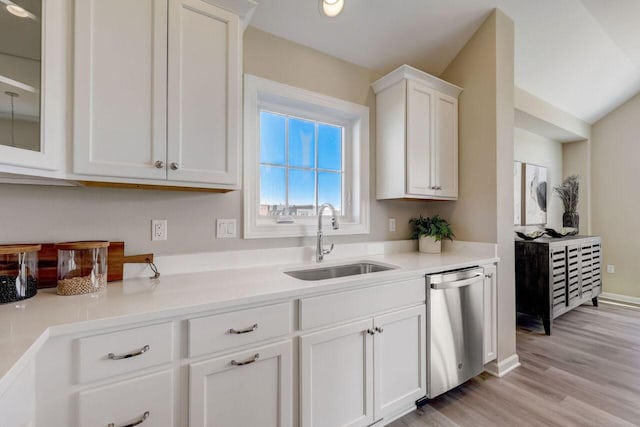 1320 Prairie Creek Cir Unit 2, Oconomowoc, WI 53066 - kitchen with dishwasher, white cabinets, light wood-style floors, and light countertops