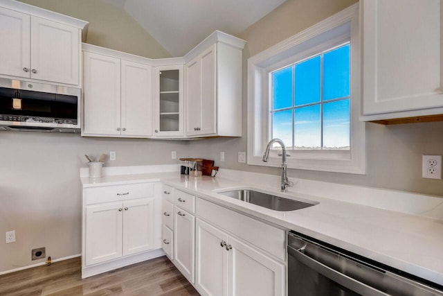 1320 Prairie Creek Cir Unit 2, Oconomowoc, WI 53066 - kitchen featuring stainless steel appliances, white cabinetry, wood finished floors, light countertops, and glass insert cabinets
