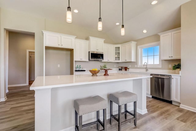 1320 Prairie Creek Cir Unit 2, Oconomowoc, WI 53066 - kitchen featuring stainless steel appliances, white cabinets, a center island, and recessed lighting