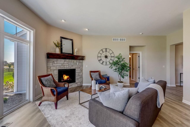 1320 Prairie Creek Cir Unit 2, Oconomowoc, WI 53066 - living area with a stone fireplace, wood finished floors, and recessed lighting
