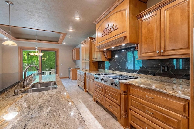 448 Harvest Rd, Green Bay, WI 54302 - kitchen with a sink, stainless steel gas stovetop, backsplash, a tray ceiling, and light stone counters