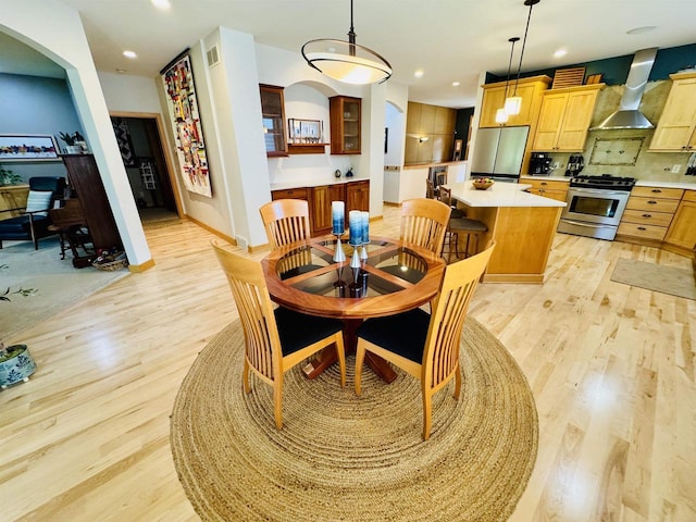2659 Dungarvan Rd, Fitchburg, WI 53711 - dining room featuring light wood finished floors, recessed lighting, baseboards, and arched walkways