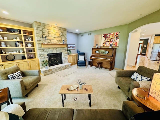 2659 Dungarvan Rd, Fitchburg, WI 53711 - carpeted living room with arched walkways, a fireplace, and recessed lighting