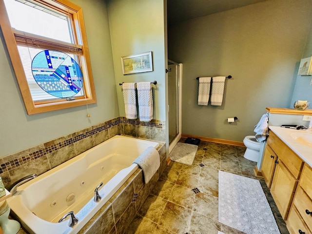 2659 Dungarvan Rd, Fitchburg, WI 53711 - bathroom with vanity, toilet, a stall shower, a jetted tub, and baseboards