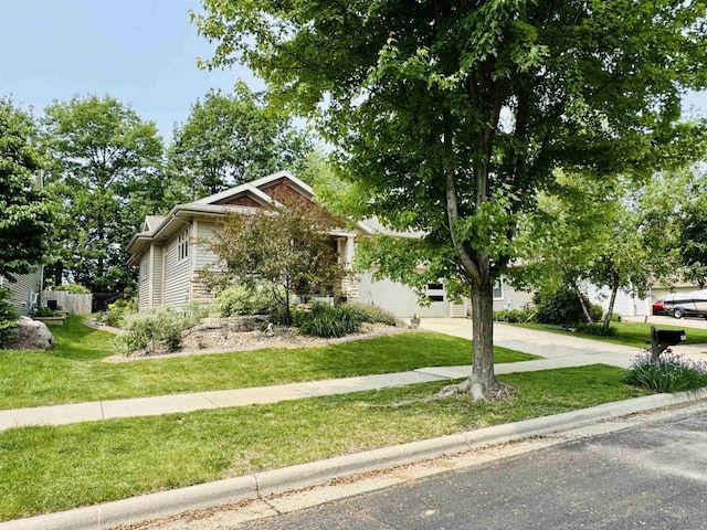 2659 Dungarvan Rd, Fitchburg, WI 53711 - obstructed view of property featuring a front yard and concrete driveway