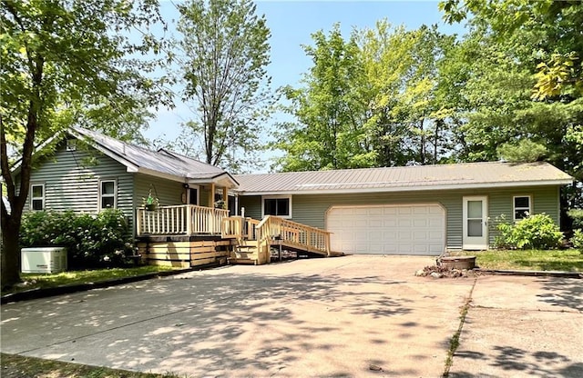 999 Mcgill Point Rd, Weyerhaeuser, WI 54895 - ranch-style house with driveway, a garage, metal roof, and a porch