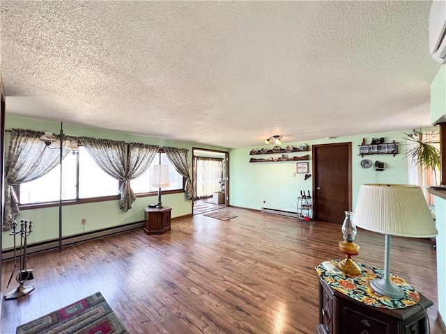 999 Mcgill Point Rd, Weyerhaeuser, WI 54895 - living area featuring a textured ceiling, wood finished floors, a wall mounted AC, baseboard heating, and a baseboard radiator