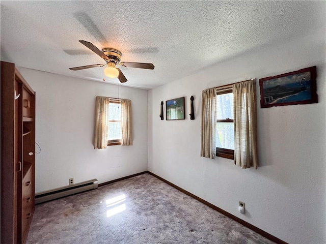 999 Mcgill Point Rd, Weyerhaeuser, WI 54895 - unfurnished room with a baseboard heating unit, ceiling fan, carpet, a textured ceiling, and baseboards