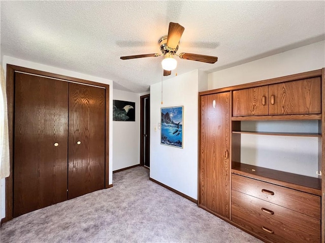 999 Mcgill Point Rd, Weyerhaeuser, WI 54895 - unfurnished bedroom with light carpet, a closet, a textured ceiling, baseboards, and a ceiling fan