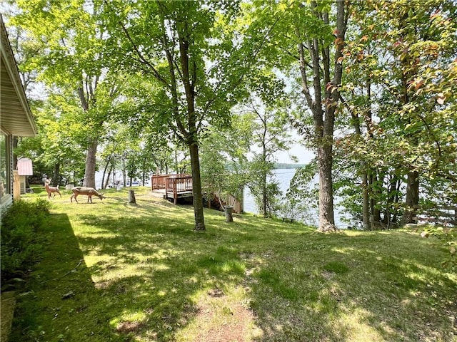 999 Mcgill Point Rd, Weyerhaeuser, WI 54895 - view of grassy yard featuring a deck with water view