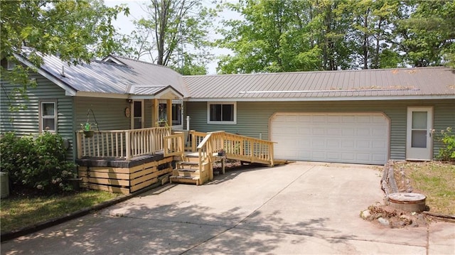 999 Mcgill Point Rd, Weyerhaeuser, WI 54895 - ranch-style home with driveway, a garage, metal roof, and covered porch