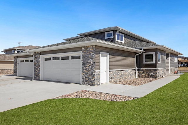 1200 Sween Dr Unit 4, Holmen, WI 54636 - view of front of property featuring stone siding, driveway, an attached garage, a front yard, and a shingled roof