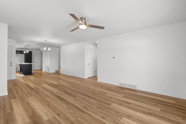 1200 Sween Dr Unit 4, Holmen, WI 54636 - unfurnished living room featuring a chandelier, ceiling fan, baseboards, and light wood-style flooring