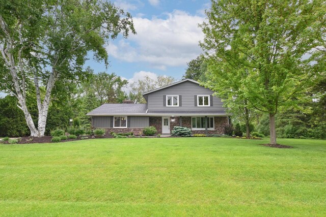 15710 Kata Dr, Elm Grove, WI 53122 - traditional-style house with a front yard and brick siding