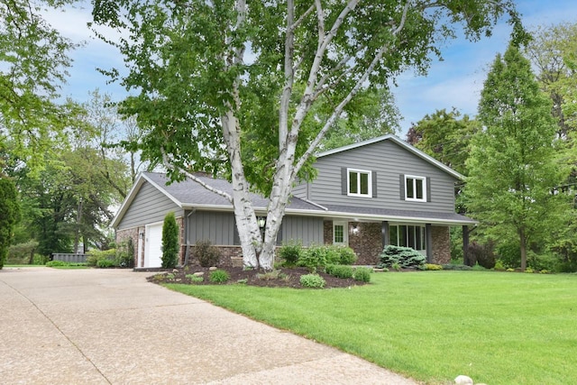 15710 Kata Dr, Elm Grove, WI 53122 - traditional home with a front yard, brick siding, a garage, and driveway