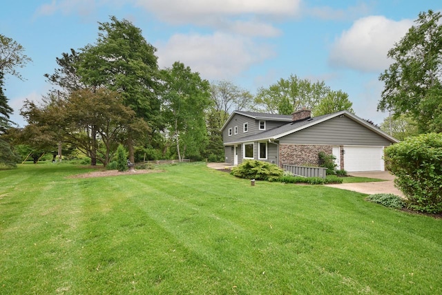 15710 Kata Dr, Elm Grove, WI 53122 - view of front of house featuring a chimney, a front yard, an attached garage, and driveway