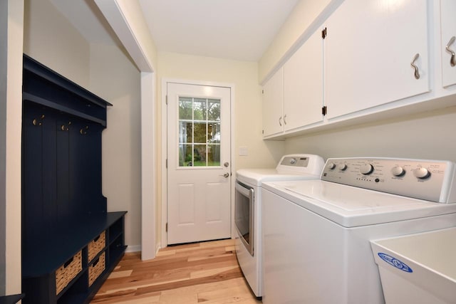 15710 Kata Dr, Elm Grove, WI 53122 - laundry room with cabinet space, independent washer and dryer, and light wood-style flooring