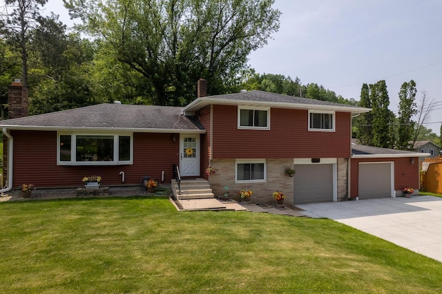 N2092 Irish Ct, La Crosse, WI 54601 - split level home with a chimney, concrete driveway, a front yard, and a shingled roof