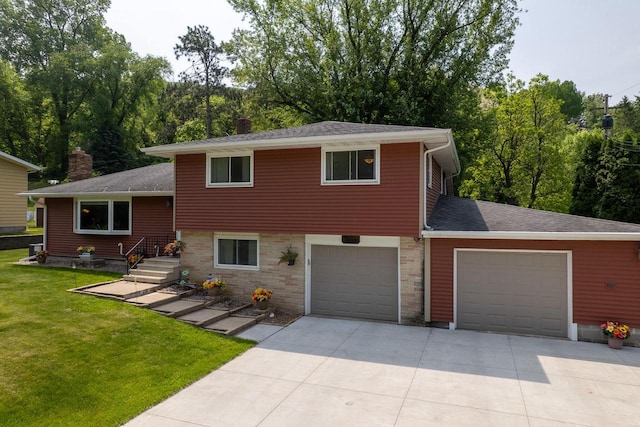 N2092 Irish Ct, La Crosse, WI 54601 - tri-level home featuring concrete driveway, a front yard, a chimney, and roof with shingles