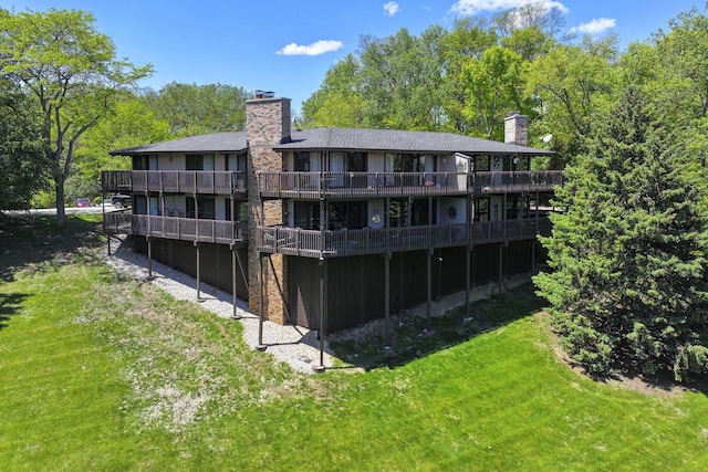 940 Alpine Dr Unit 01, Fontana, WI 53125 - back of property featuring a chimney, a yard, and a deck