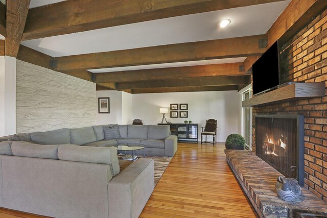 940 Alpine Dr Unit 01, Fontana, WI 53125 - living area with beam ceiling, light wood-style floors, and a brick fireplace