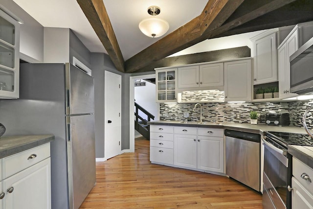 940 Alpine Dr Unit 01, Fontana, WI 53125 - kitchen with appliances with stainless steel finishes, a sink, tasteful backsplash, and light wood finished floors