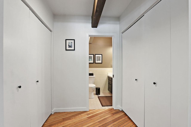 940 Alpine Dr Unit 01, Fontana, WI 53125 - hall with light wood-type flooring, beam ceiling, and tile walls
