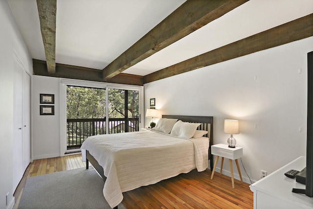 940 Alpine Dr Unit 01, Fontana, WI 53125 - bedroom featuring access to outside, beam ceiling, baseboards, and hardwood / wood-style flooring
