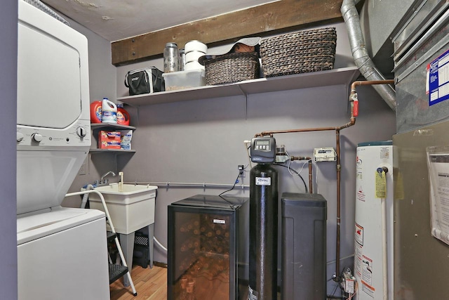 940 Alpine Dr Unit 01, Fontana, WI 53125 - washroom with stacked washer / dryer, water heater, and light wood-style floors