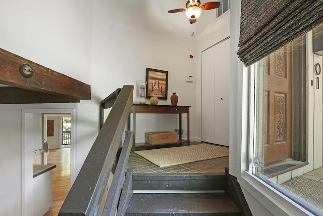 940 Alpine Dr Unit 01, Fontana, WI 53125 - stairway with a ceiling fan, a high ceiling, and wood finished floors