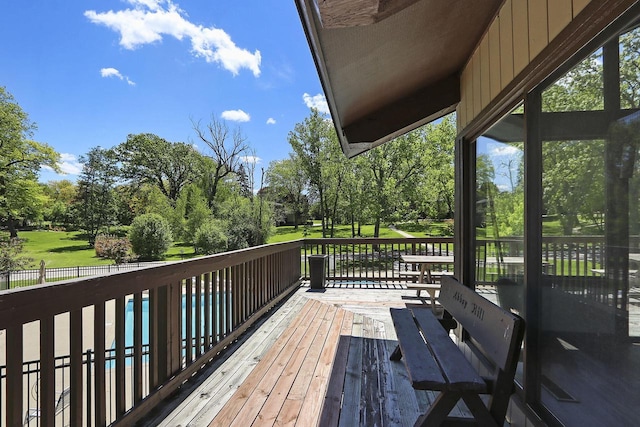 940 Alpine Dr Unit 01, Fontana, WI 53125 - wooden terrace featuring view of scattered trees and a pool