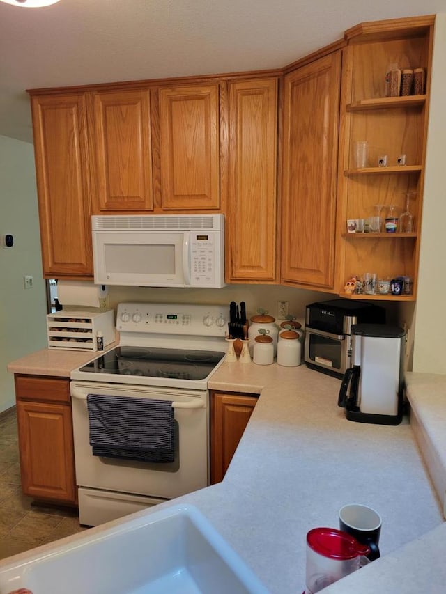 2832 E Somers Ct, Cudahy, WI 53110 - kitchen with white appliances, light countertops, open shelves, and brown cabinetry