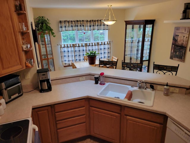 2832 E Somers Ct, Cudahy, WI 53110 - kitchen featuring a sink, dishwasher, light countertops, and pendant lighting