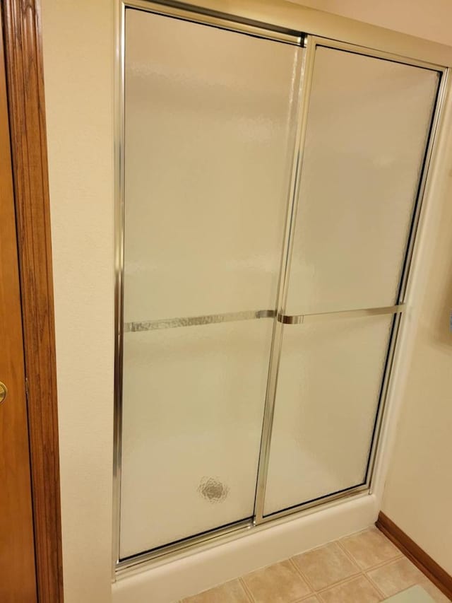 2832 E Somers Ct, Cudahy, WI 53110 - bathroom featuring a shower stall, tile patterned floors, and baseboards